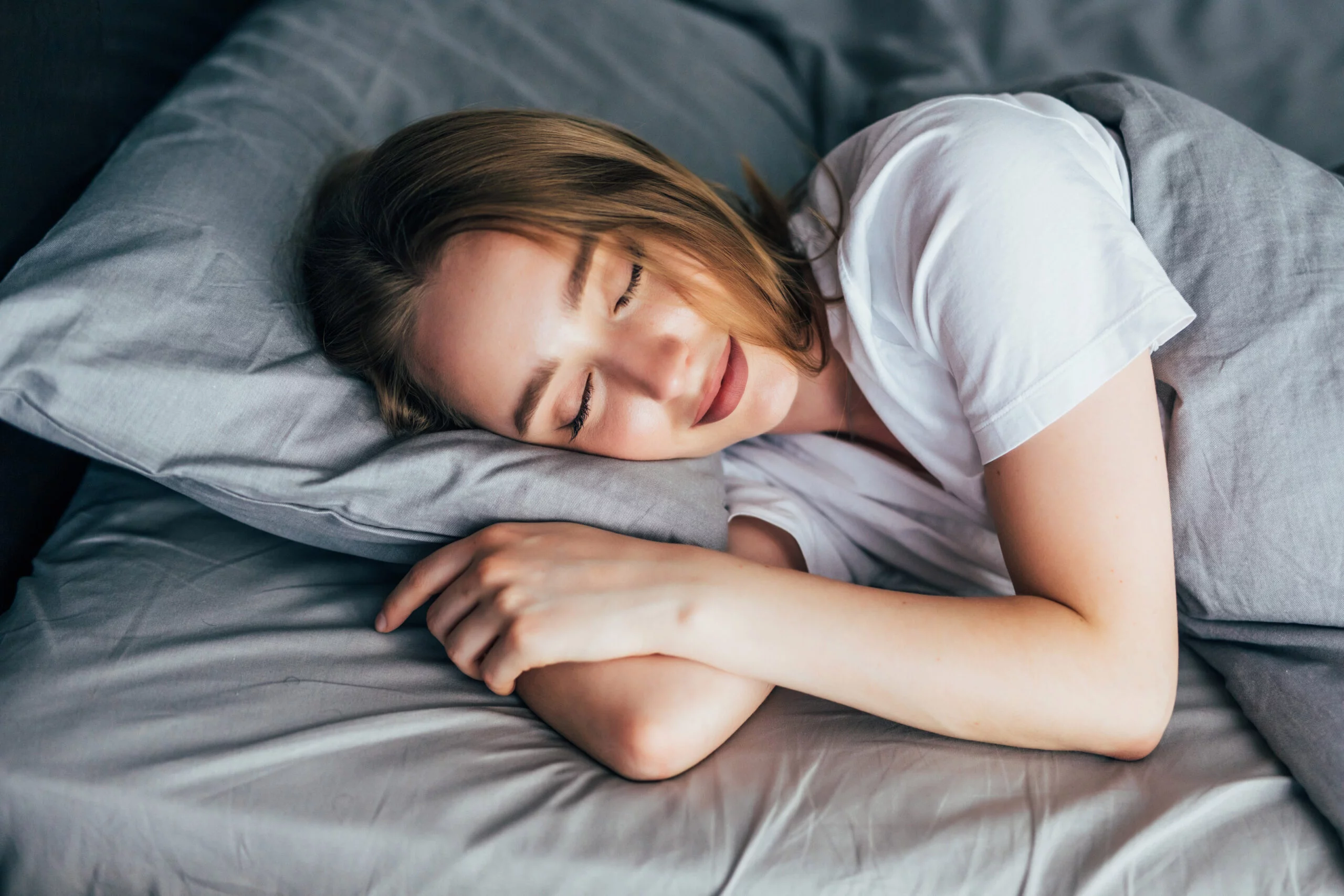 Photographie d'une femme dormant dans son lit